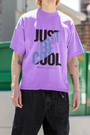 Front view of Urbaxo's Just Be Cool oversized T-shirt in black, featuring bold typography across the chest.

