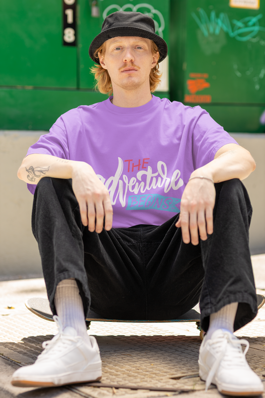 Model wearing the lavender Adventure T-shirt from Urbaxo, front-facing with casual styling.
