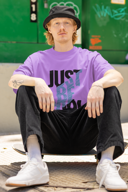 Model wearing the Just Be Cool oversized T-shirt from Urbaxo, front view with casual styling.

