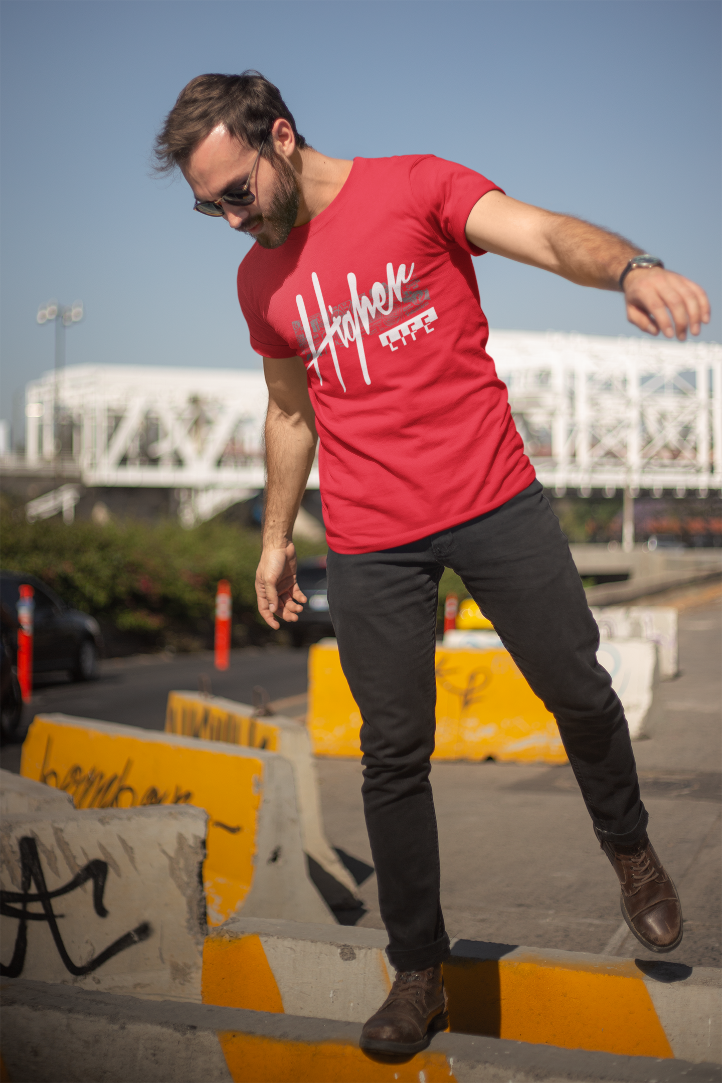 Model in TUY Higher Life red T-shirt by Urbaxo, styled with casual bottoms, showing off the vibrant color and laid-back fit